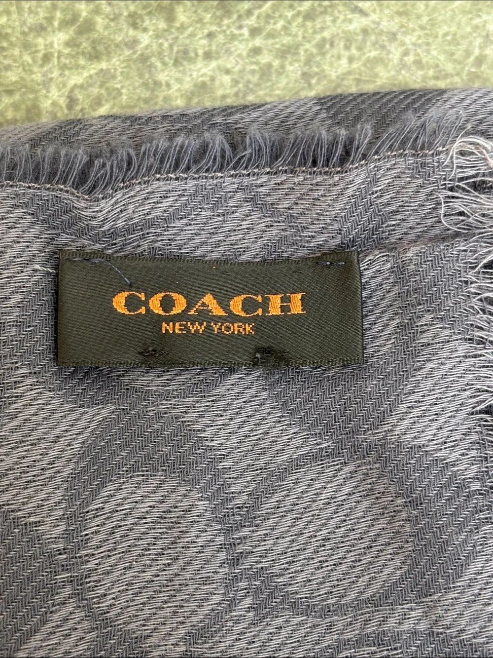 Coach Signature Wrap  made from a wool and silk blend with a tonal jacquard logo